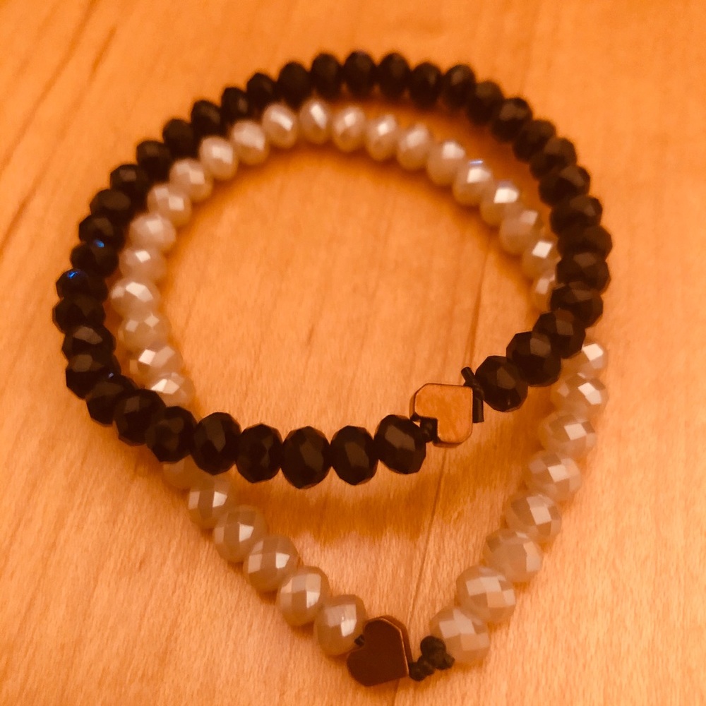 Bracelets white and black with gold hearts.